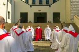 The community processes into the abbey church on Palm Sunday